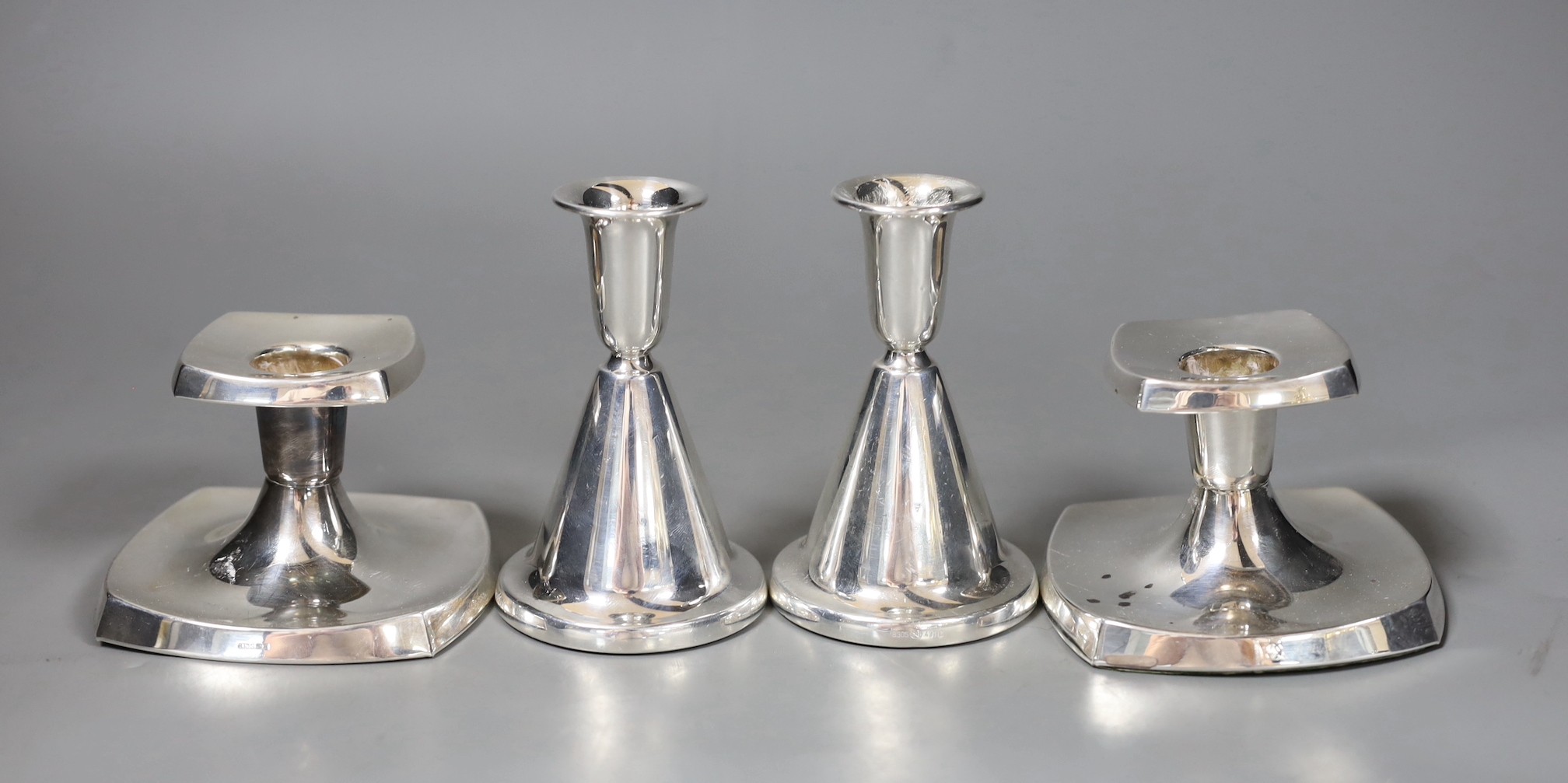 Two pairs of 20th century Scandinavian 830 standard white metal dwarf candlesticks, tallest 10.7cm.